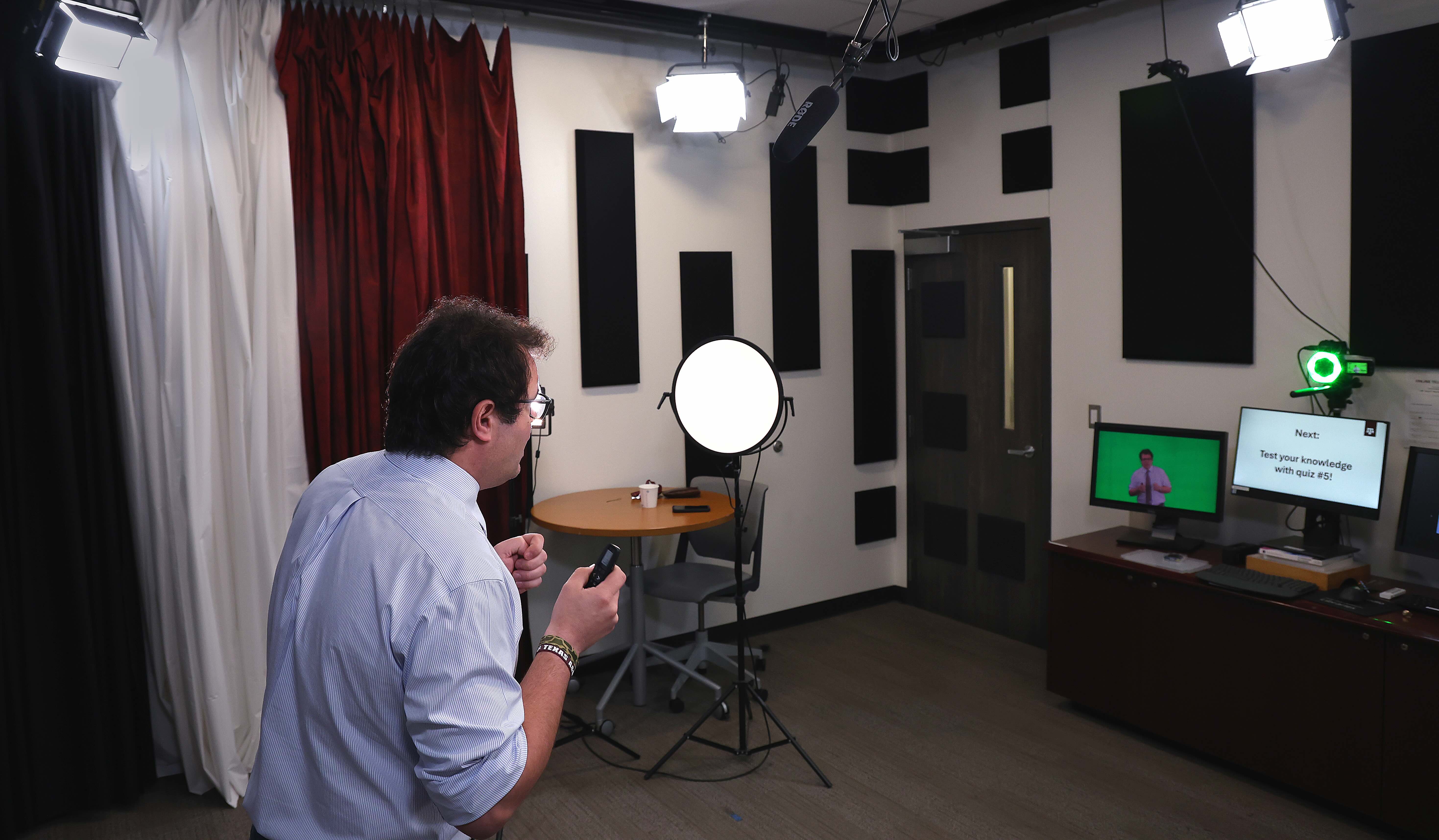 Dr. Rossi records a lecture in a studio. The camera and green screen video feedback are visible.